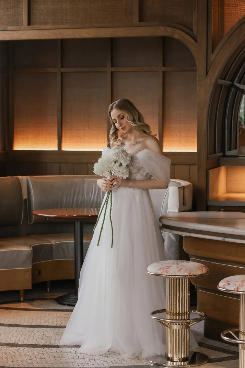 Off-the-shoulder sleeves gathered into floral volume