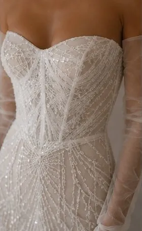 Close detail of the embroidered lace on the Leocadia wedding gown