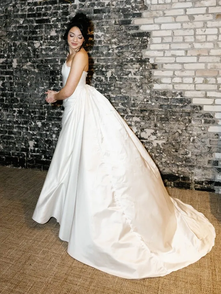Bride in a heavyweight silk gown with a detachable overskirt, made to measure by Safonova Couture